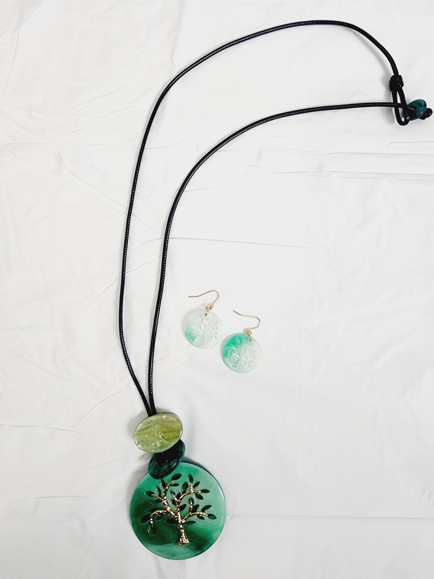Set of earrings and long necklace with tree of life