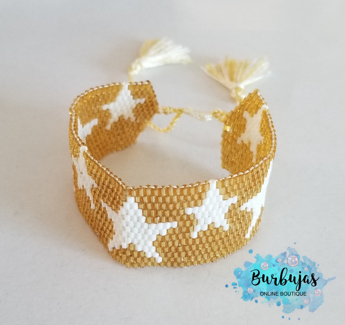 Wide golden bracelet with stars