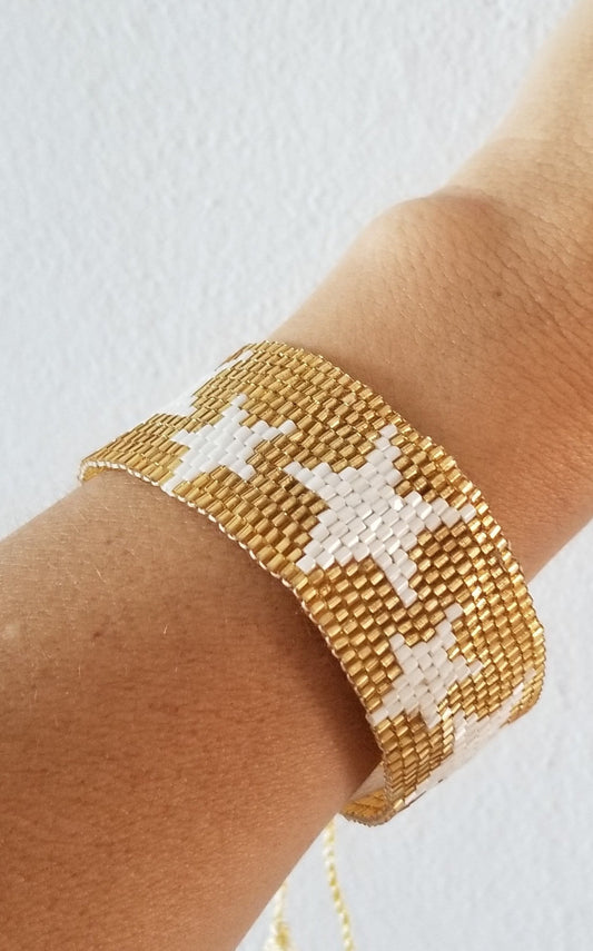 Wide golden bracelet with stars